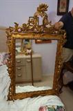Italian mirror, 20th century, heavy carved and gilt 48 inches by 30 inches.