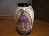 Moorcroft small vase with marroon flowers.
One of 17 pieces available in this collection.