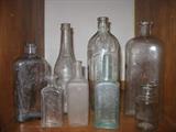 goup of small and large old bottles