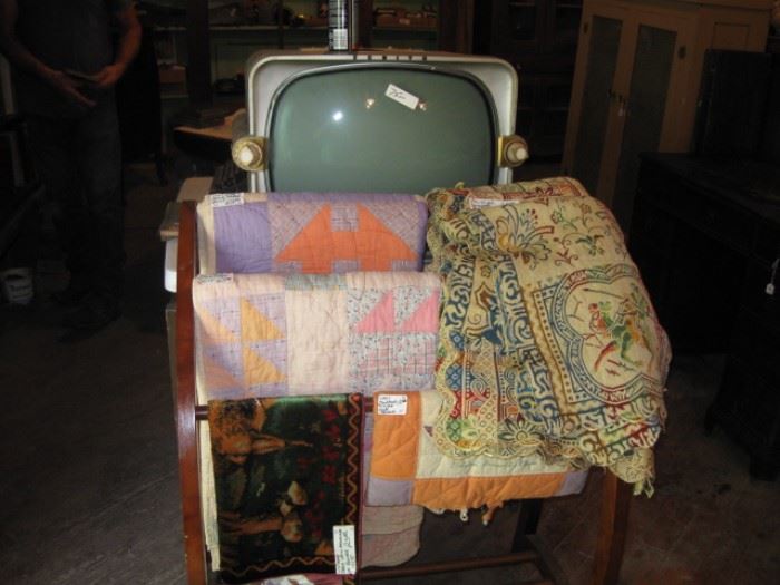 Quilts and tapestries and old Zenith tv w/ original instruction book