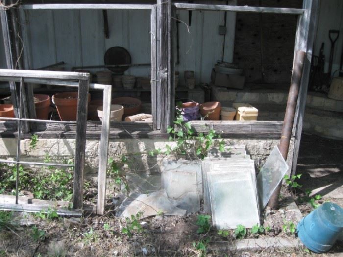 Old windows, glass window panes and garden pots