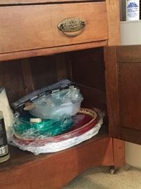 Antique cabinet with pegged drawer and on casters.