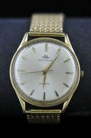 Lot 49: Gentleman's 14k gold Movado watch with a 14k gold band, 74 grams