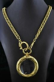 Lot 53: Chanel necklace with magnifying glass, 36" long chain, marked Chanel, made in Paris