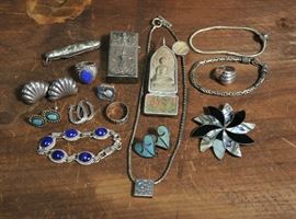 Lot 52: Sterling silver lot; lighter case, pin, pendants, several pairs of earrings, bracelets and rings (68 & 73)