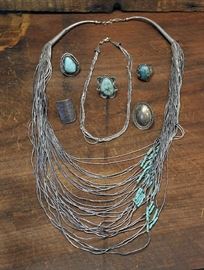 Lot 70: Five assorted sterling silver rings, some with stones along with two liquid silver necklaces, one with large piece of turquoise (56 & 70)