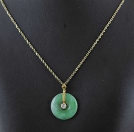 Lot 73: 14k gold jade and diamond disc pendant on 14k gold chain