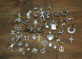 Lot 76: Sterling silver lot: rings, pendants, and an assortment of pins (39 & 46)