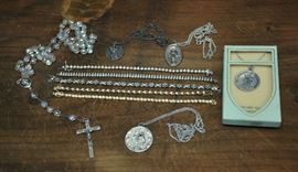 Lot 102: Sterling lot; five bracelets, some with stones along with silver religious medals (80 and 99)