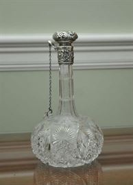 Cut glass decanter with sterling rim