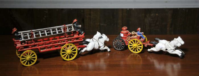 Cast iron horse drawn fire ladder wagon along with cast iron horse drawn fire pumper wagon
