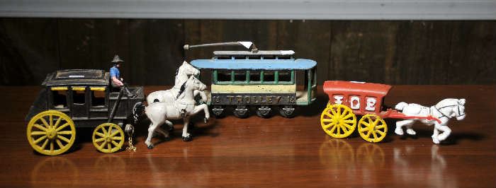 Cast iron horse drawn ice wagon, cast iron horse drawn stagecoach along with cast iron electric trolley
