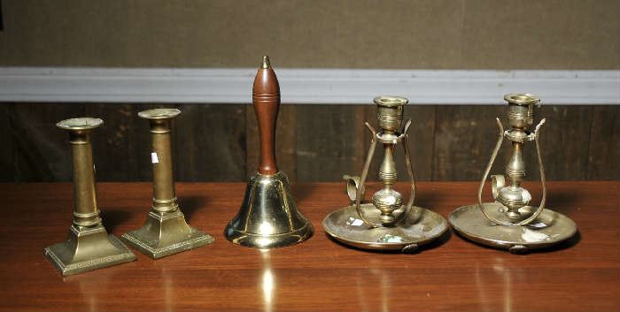 Brass dinner bell, brass ships candlesticks along with brass push-up candlesticks
