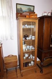 curio cabinet with tea cups