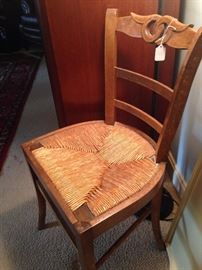 One of two matching rush seat chairs