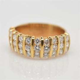18K Yellow Gold 1.20 CTW Diamond Ring: An 18K yellow gold diamond band composed of 1.20 ctw in round brilliant cut channel set diamonds.