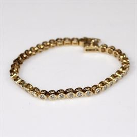 Diamond Bracelet: A yellow gold and diamond bracelet purchased from Don Hudepohl Jewelers, in original case.