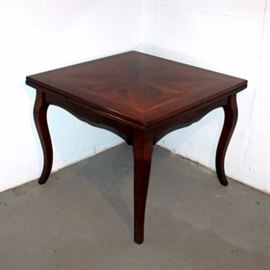 Expandable Dining Table From Arhaus: A dining table from Arhaus with refectory leaves. There are two leaves stored inside the table, which can be easily pulled out to convert the table from 39″ × 39″ to 71″ × 39″. The handsome table has a marquetry design on top, graceful cabriole legs and a shaped apron.