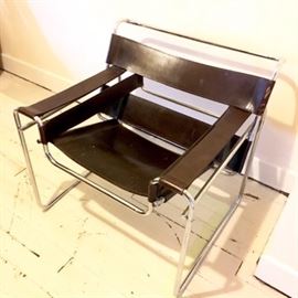 Marcel Breuer "Wassily" Chair: A “Wassily” lounge chair by Marcel Breuer. This iconic piece features a tubular steel frame with a polished chrome finish. The seat, armrests and back are fabricated from double-faced, thick, chocolate brown leather. The piece dates to the mid 1970s.