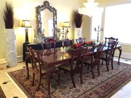 Chippendale style in a cherry finish with four leafs and eight chairs.