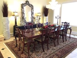 Chippendale style in a cherry finish with four leafs and eight chairs.