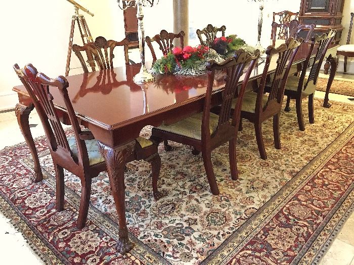Chippendale style in a cherry finish with four leafs and eight chairs.