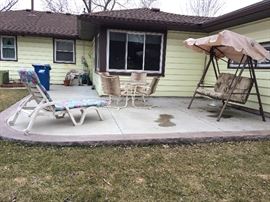 Patio furniture including lounger, table and 4 chairs, and swing
