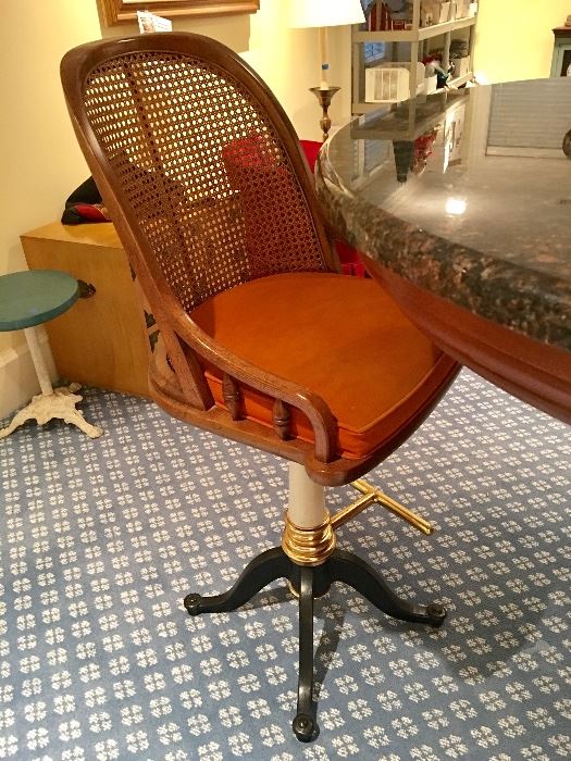 1 of 6 caned bar stools with wrought iron base and brass foot rests