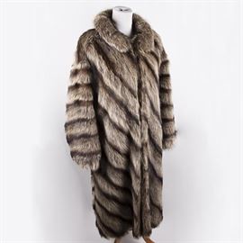 Women's Raccoon Fur Coat: A full-length raccoon coat. The coat features a Peter Pan collar and raglan sleeves. The inside of the coat is embroidered with roses and the label reads “Rame Gurwitch.”
