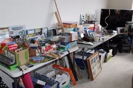 Office supplies, packs of paper, boxes of envelopes and files. Picture frames, radios, clocks, scissors.