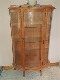 Lighted round glass curio cabinet