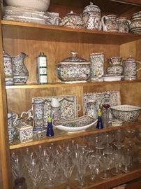 Tons of beautiful ceramic dishware from Portugal and Italy. Below that you can see a large collection of Waterford Sheila.