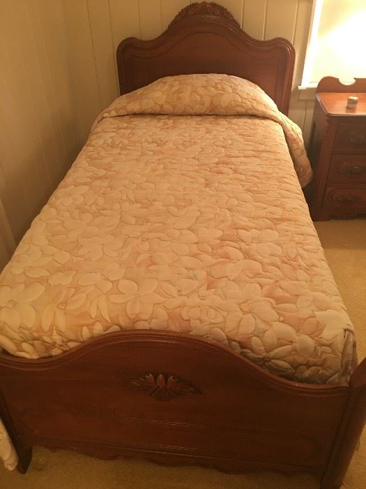 one of two matching twin grape carved Walnut beds by Davis cabinet company 