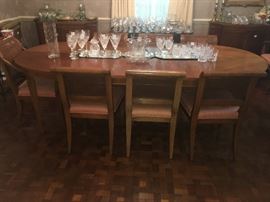 dining room with 8 matching chairs and various collection of crystal