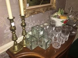 assortment of candle holders and crystal
