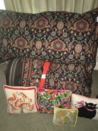 various needle point pillows and bed spreads and bed linens