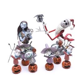 Disney Showcase Nightmare Before Christmas Figurines: A set of Disney Showcase Nightmare before Christmas figurines. This selection includes the Santa Jack Skellington, numbered 2762 of 3000, and the Sally numbered 2643 out of 3000. Along with two sets of the treaters Lock, Shock, and Barrel. All of the pieces include the original packaging and have branding marks to the underside.