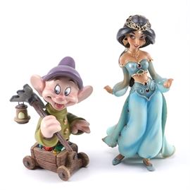 Limited Edition Disney Showcase Collectible Figurines: A pair of Disney Showcase figurines. This pairing includes one “Jasmine” figurine from the film Aladdin and one “Dopey” dwarf figurine from Snow White. The “Dopey” figurine is hand numbered to the underside of the base “0277 of 3,000, Made in China.” The “Jasmine” figurine is marked to the base “© Disney, Made in China.” These items are primarily for decorative purposes and not for play.
