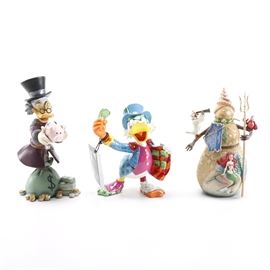 Walt Disney Figurines Including "Scrooge McDuck": A group of Walt Disney Showcase Collection figurines. This group includes Scrooge McDuck number 0797 of 3000, marked “4032474”; Britto; Uncle Scrooge marked “4051800”; Christmas by The Sea marked “4046021”. All come in the original box.