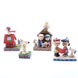 Peanuts Figurines by Jim Shore: A collection of Peanuts figurines by Jim Shore. This selection includes The Flying Ace, The Christmas Play, Hug Time, and Peace on Earth. Each is made in stone resin and depicts Lucy, Charlie Brown, Snoopy, and Woodstock.