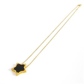 14K Gold Onyx Star Necklace: A yellow gold necklace chain with a star-shaped pendant of black stone in a prong setting.