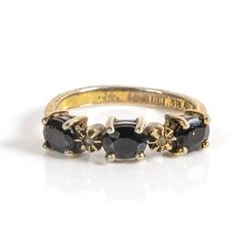 Sterling Ring with Blue Spinel Stones: A gold plated sterling silver ring featuring three prong-set dark blue stones and two small colorless stones.