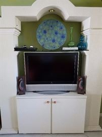 Visio TV and unique white entertainment center.