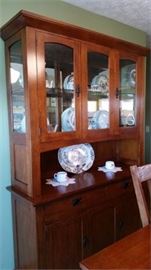 Solid Oak, Mission Style, Dining Table With 2 Leaves, pads and 6 Dining Chairs and 2 armed chairs.  Matching Sideboard and Lighted Buffet.  Table and chairs have been photographed in a 4 place setting state.  The table extends to accommodate seating for 8 when the 2 solid wood leaves and pads to protect the table.  This is a beautiful set.  