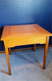 Family Board Games with a Twist.  All the game pieces and boards are kept in this cleaver little table.  The Table top flips to one of 4 game boards:

Scrabble, Monopoly, Chess or Backgammon