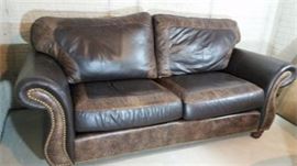 Brown Leather couch with 2" paisley leather trim.