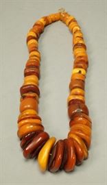 Lot 554 Tribal Graduated Amber Bead Necklace. Amber beads