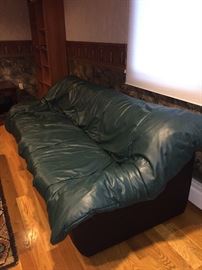...that has this funky forest green leather sleeper sofa...