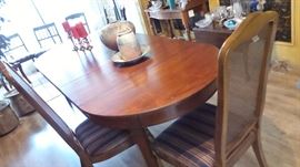 Antique dining room table refinished last year. Large oval with 3 leaves to small round. 3 sets of chairs