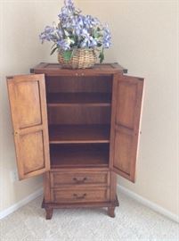 Dresser with cane accents. 24"W x 48"H x 16"D.